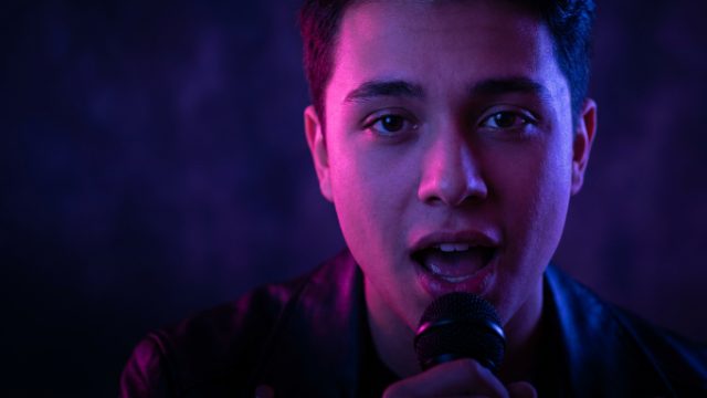 A singer singing into the camera